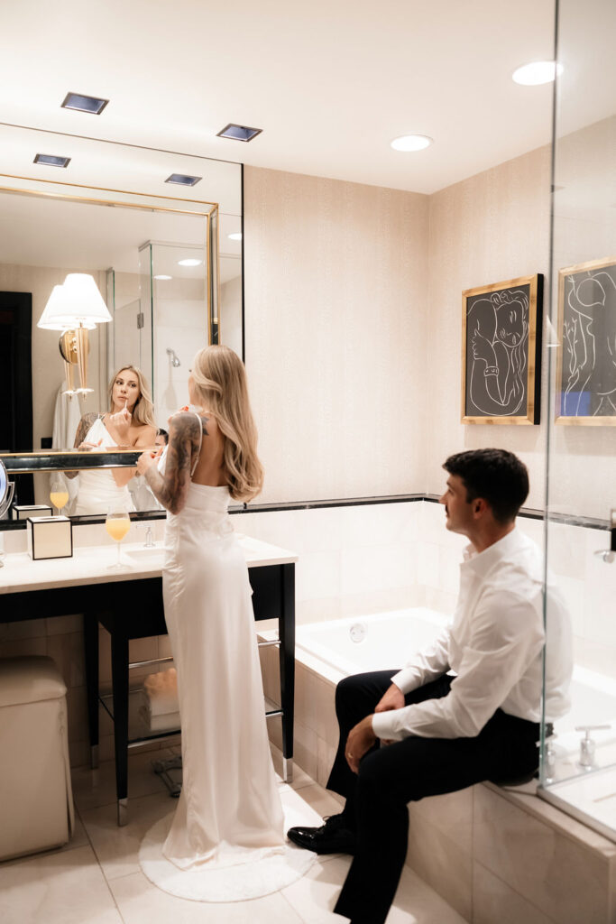 Bride and groom getting ready in their suite for their Las Vegas hotel elopement 