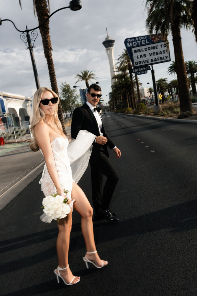 Bride and groom walking across the street during their Little White Chapel in Las Vegas