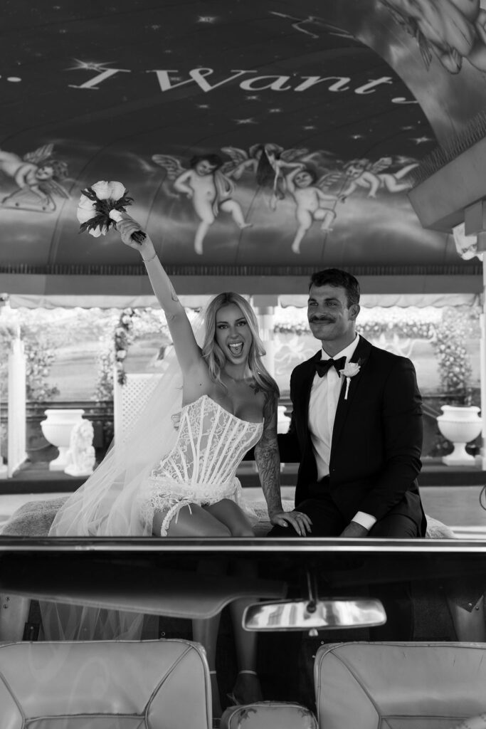 Black and white elopement photo of a bride and groom during their Pink Cadillac Ceremony