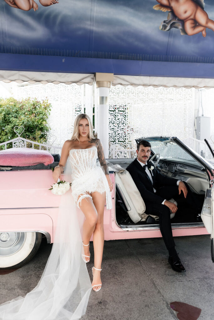 Bride and grooms editorial portraits in the Pink Cadillac at The Little White Wedding Chapel