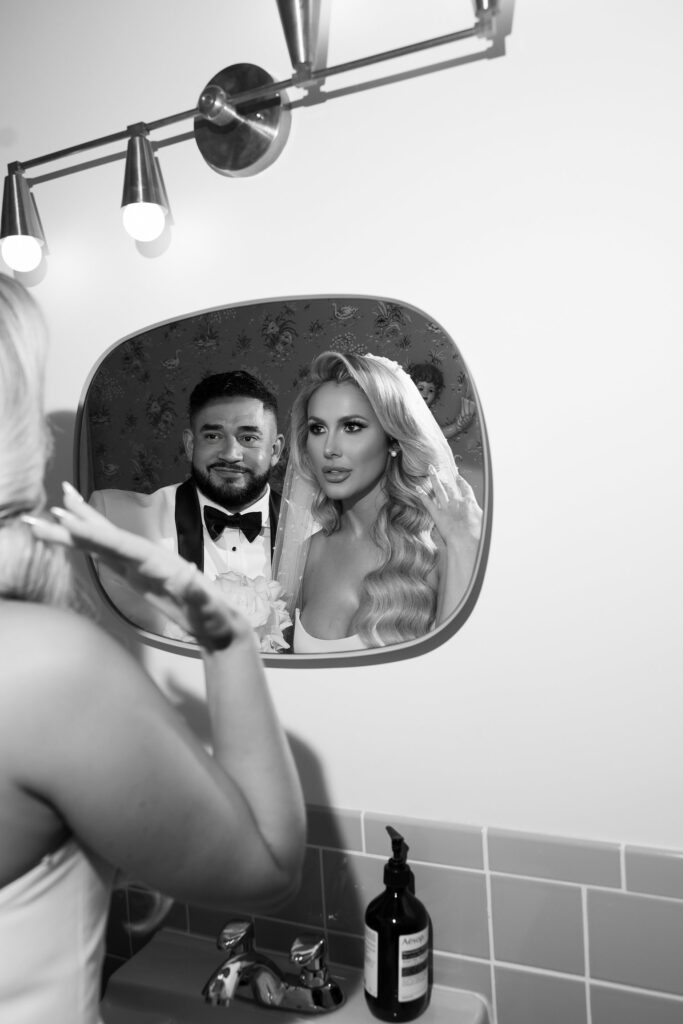 Black and white photo of a bride and groom in the bathroom at Sure Thing Wedding Chapel Las Vegas