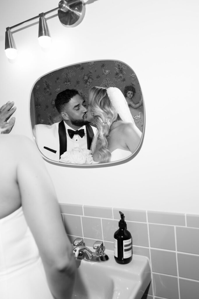 Black and white photo of a bride and groom in the bathroom at Sure Thing Wedding Chapel Las Vegas