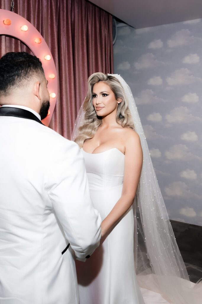 Bride and groom holding hands during the ceremony