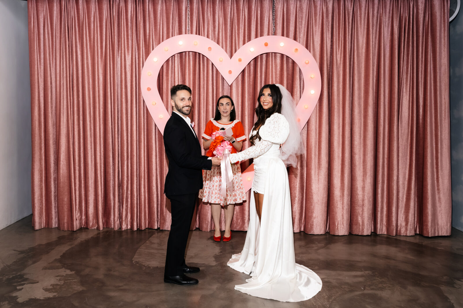 Bride and groom holding hands during their Sure Thing Chapel elopement ceremony