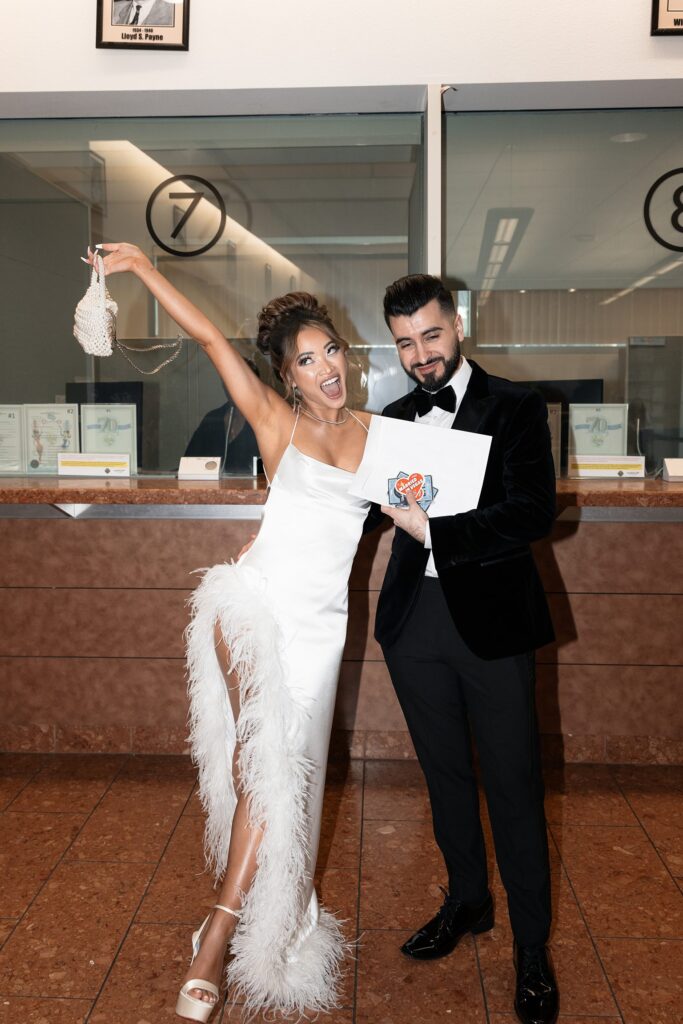 Bride and groom showing off their Las Vegas marriage license