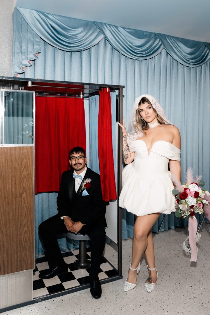 Bride and groom posing with the vintage analog photo booth at Sure Thing Too