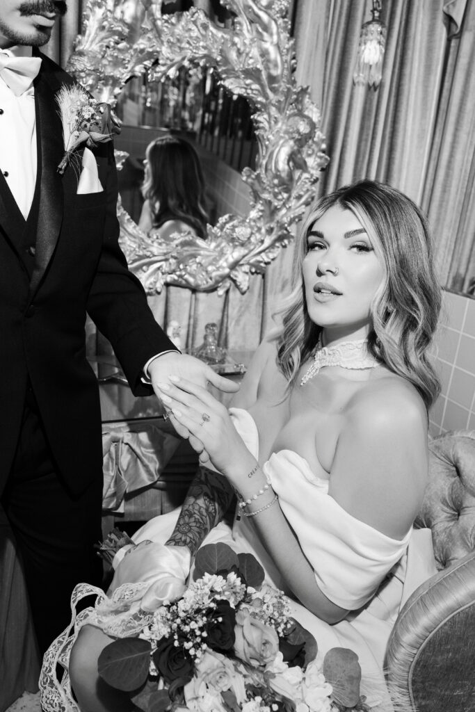 Black and white photo of a bride and groom posing in the bathroom at Sure Thing Too