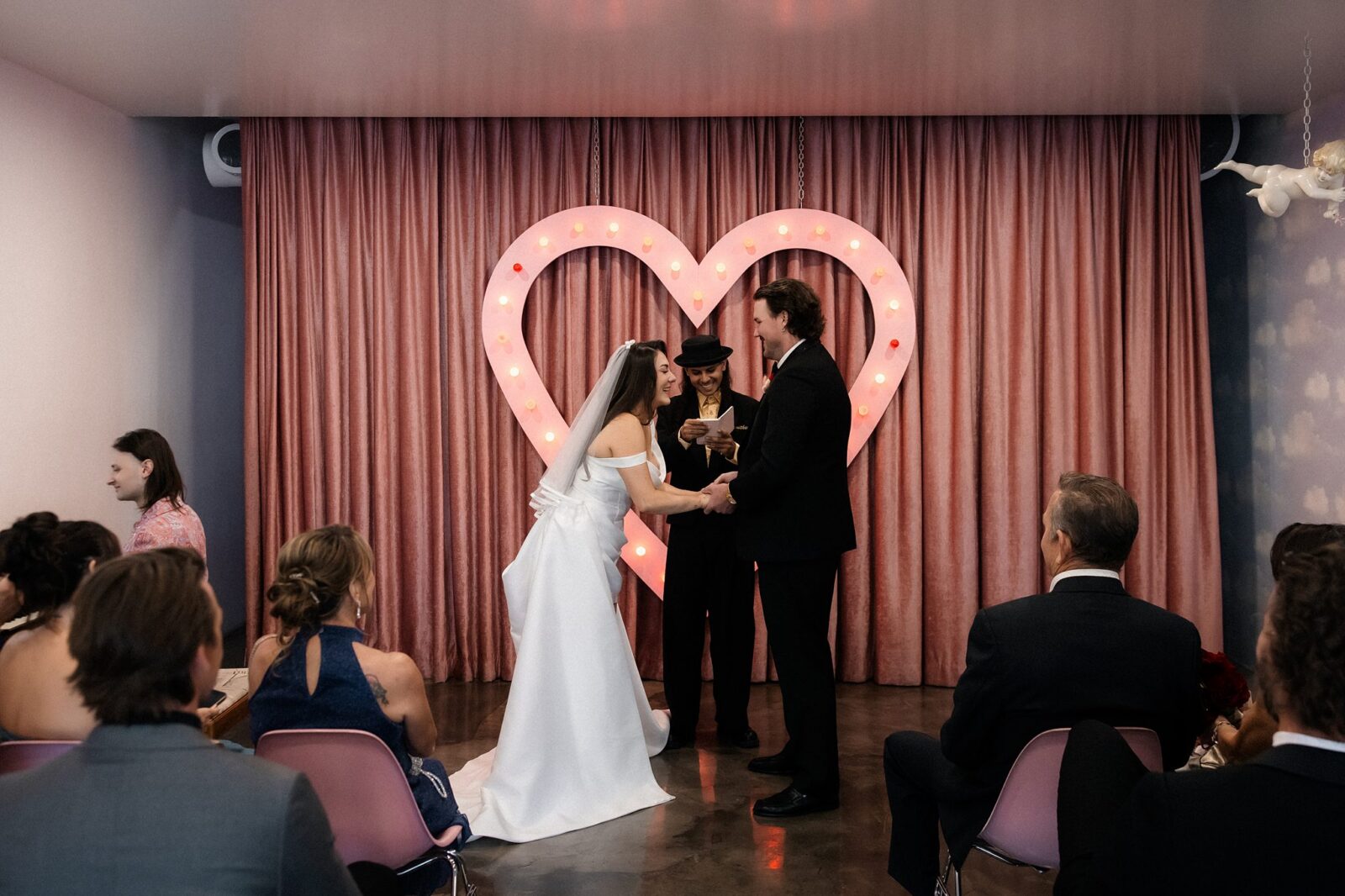 Bride and groom standing at the altar during their Sure Thing Chapel wedding ceremony.