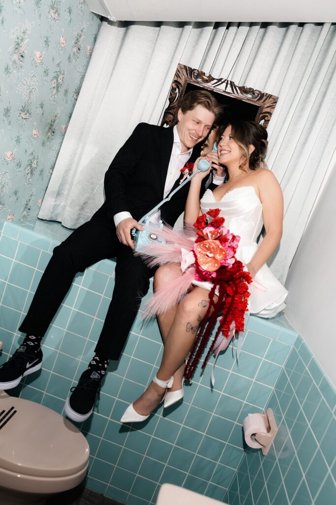 Bride and groom posing inside Sure Thing Chapels bathrom.