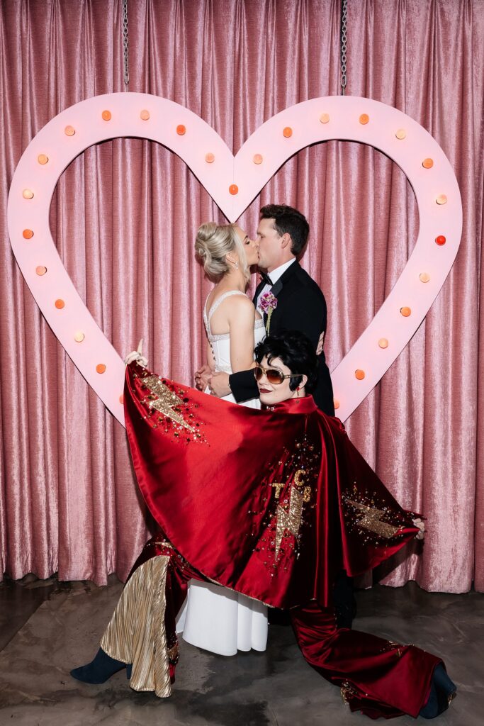Bride and groom posing with Lady Elvis for their Sure Thing Chapel wedding photos