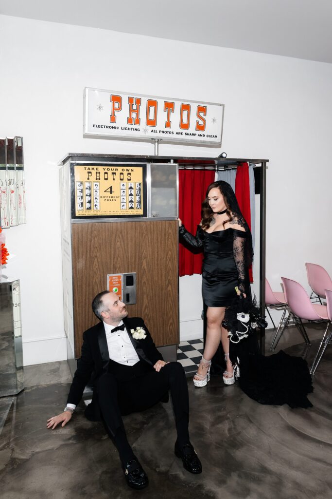 Bride and groom posing with the vintage analog photobooth at Sure Thing Chapel in Las Vegas