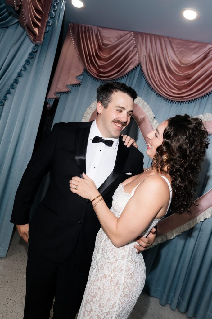Bride and groom posing in front of Sure Thing Too in Las Vegas.