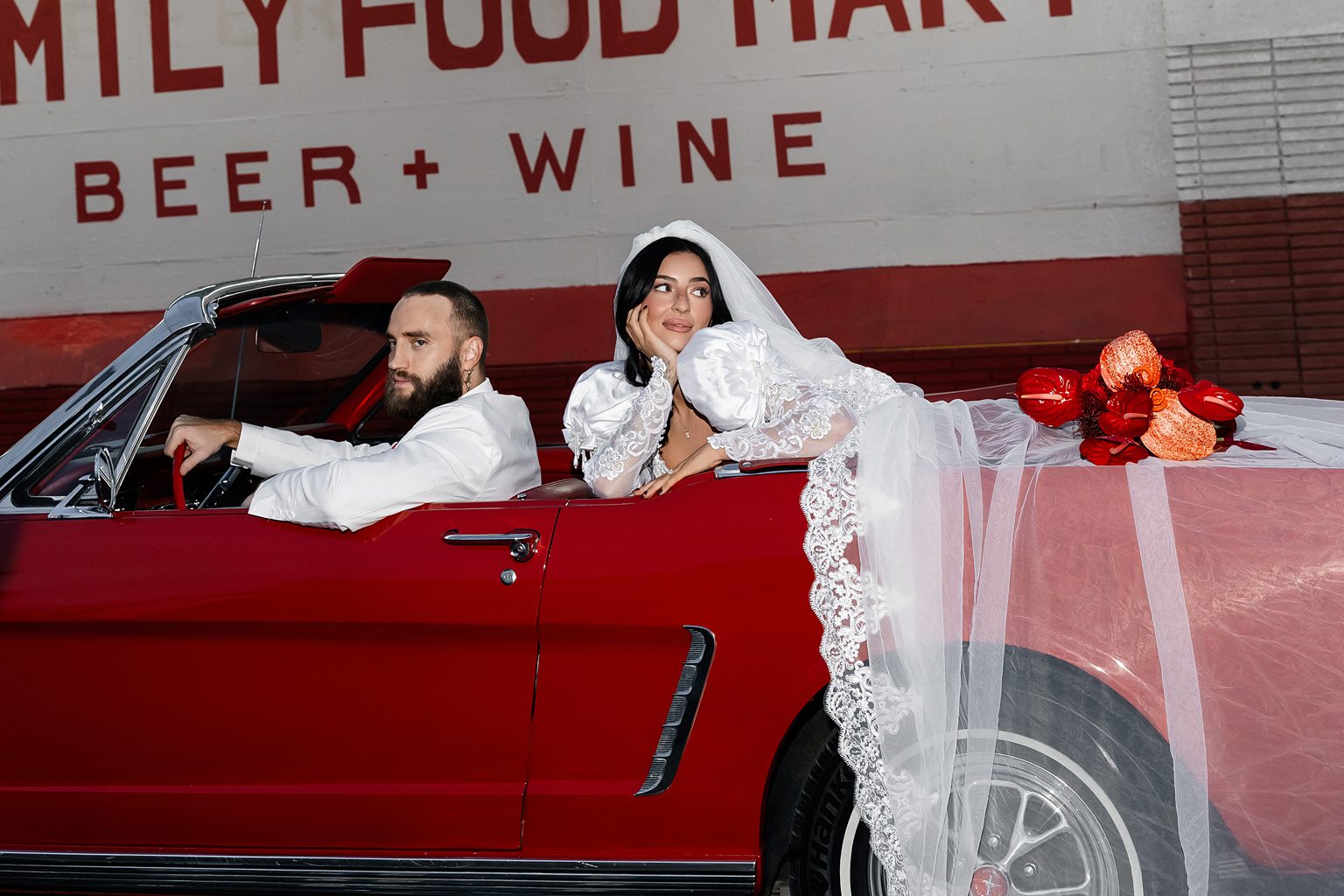 Bride and groom posing in a classic red car 5 Mistakes to Avoid When Eloping in Vegas