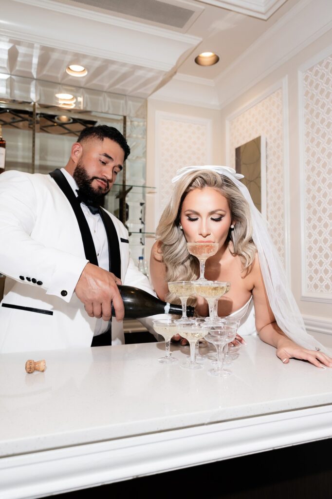 Bride and groom drinking from a champagne tower