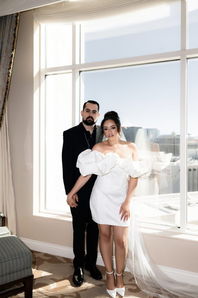 Couple posing in their suite at The Venetian for their Las Vegas elopement photoshoot