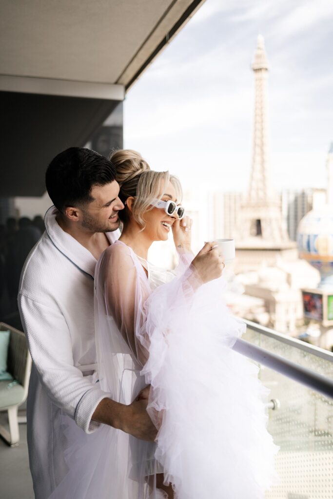 Couple posing on their wrap-around suite at The Cosmopolitan for their Las Vegas elopement