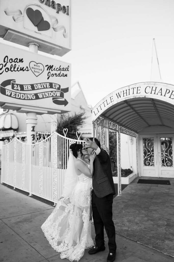 Couple posing outside of The Little White Wedding Chapel in Las Vegas