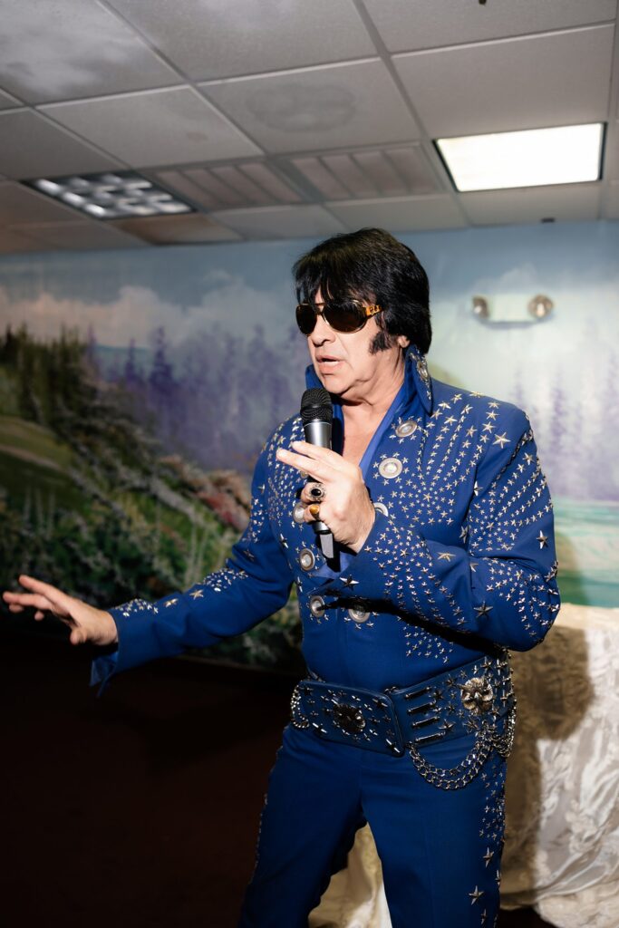 Elvis impersonator singing during a Little White Chapel ceremony