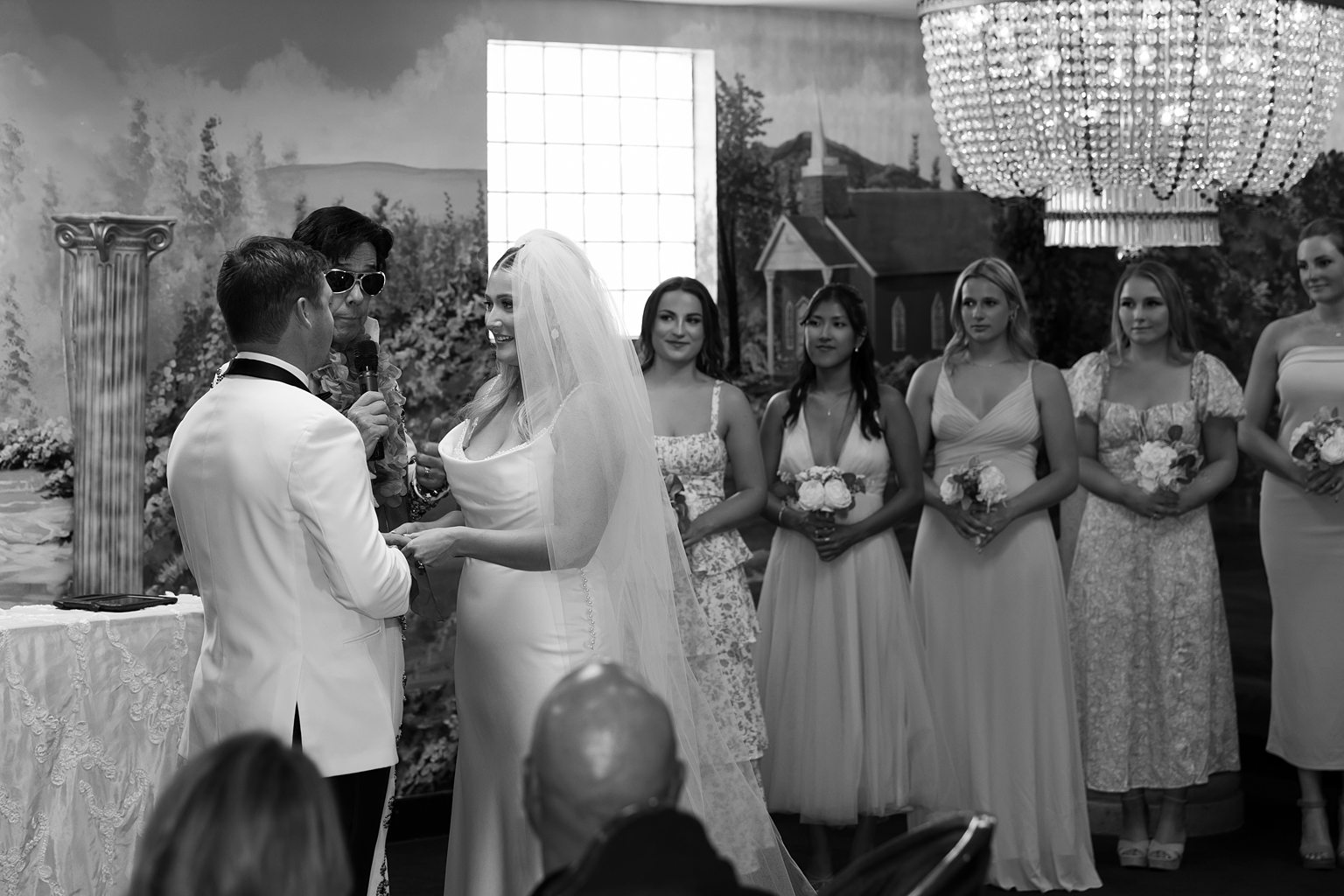 Black and white photo of a couple holding hands during their Amore Chapel elopement ceremony in Las Vegas