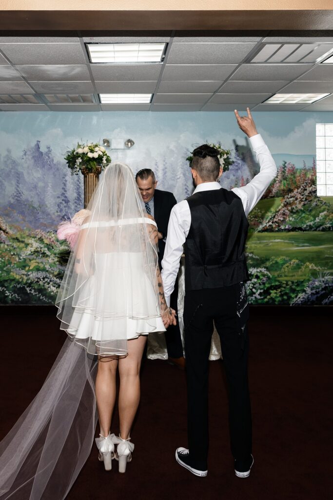 Bride and groom standing at the altar during their Chapel Amore Las Vegas wedding ceremony.