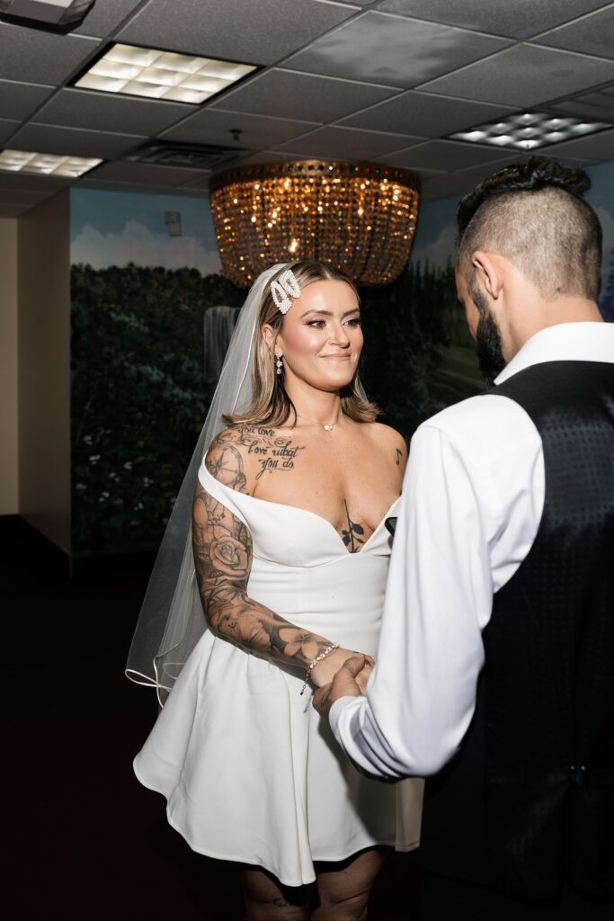 Bride and groom holding hands during their Chapel Amore Las Vegas wedding ceremony.