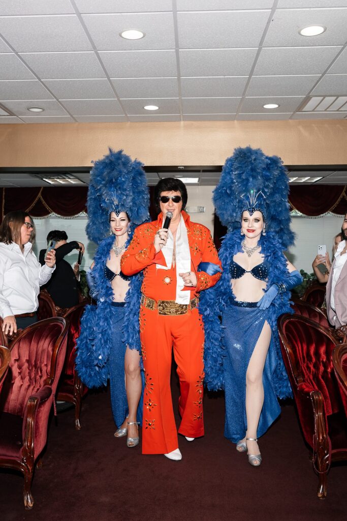 Elvis walking and singing down the aisle with Showgirls at Chapel Amore in Las Vegas.