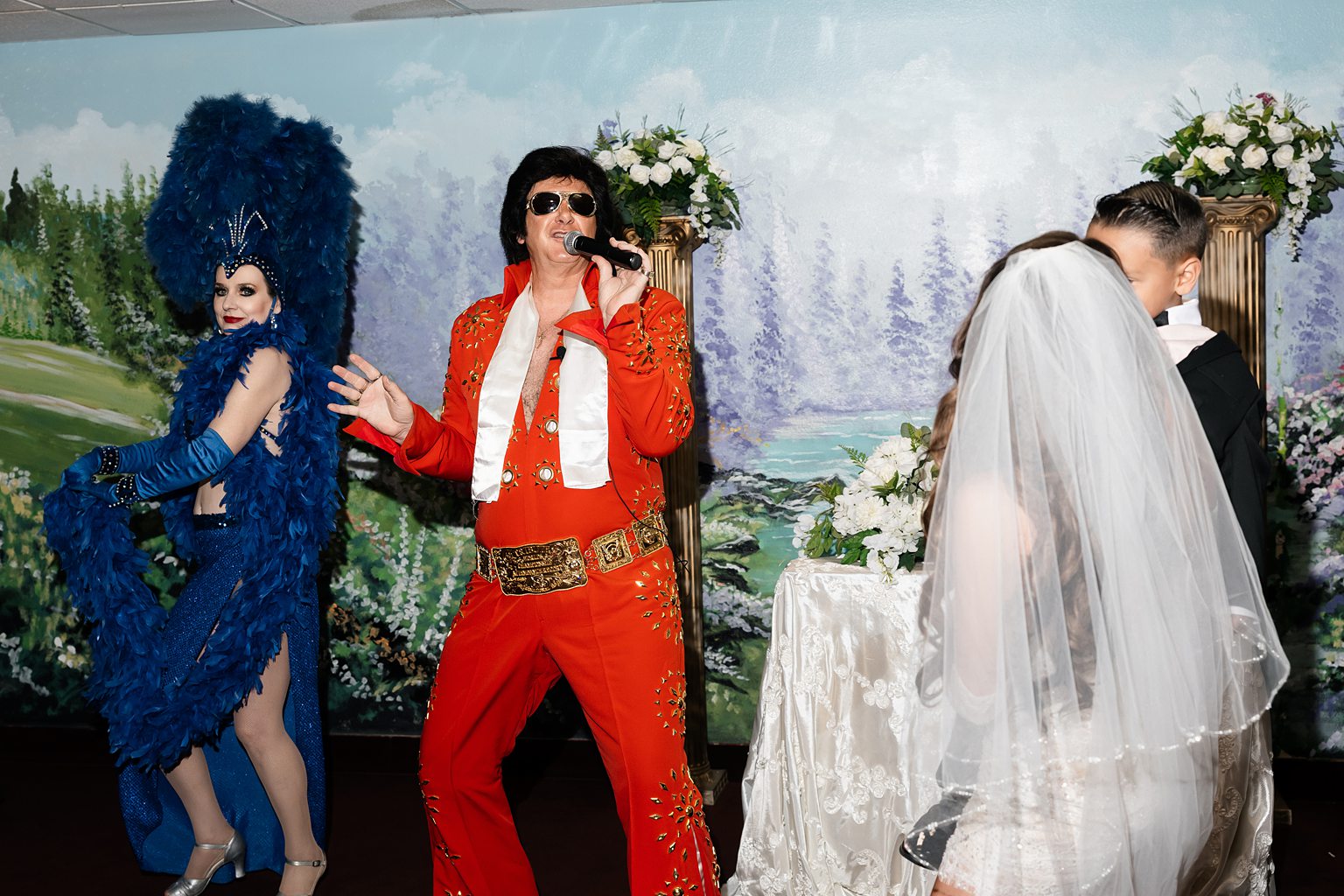 Bride and groom being serenaded by Elvis during their Chapel Amore Las Vegas wedding. 