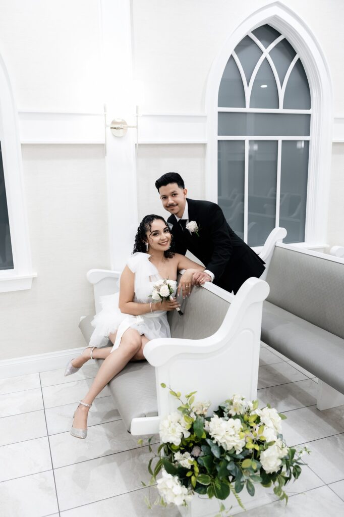 Bride and groom posing in the ceremony seats during their Bliss Wedding Chapel Las Vegas elopement