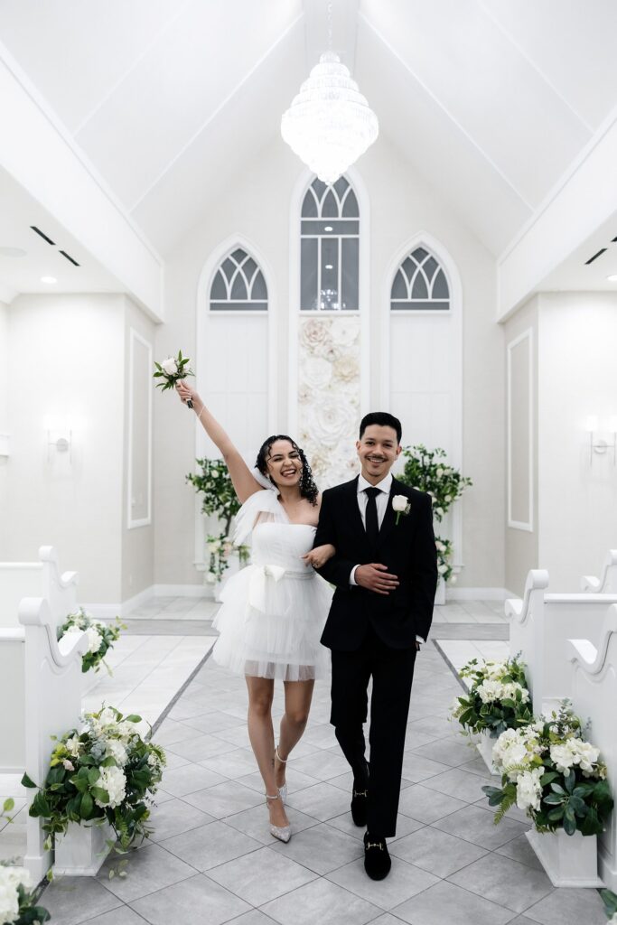 Bride and groom walking back down the aisle as husband and wife after their Bliss Wedding Chapel elopement