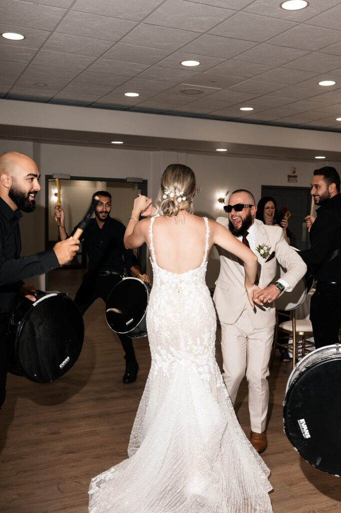 Bride and groom dancing during their wedding reception drum entrance