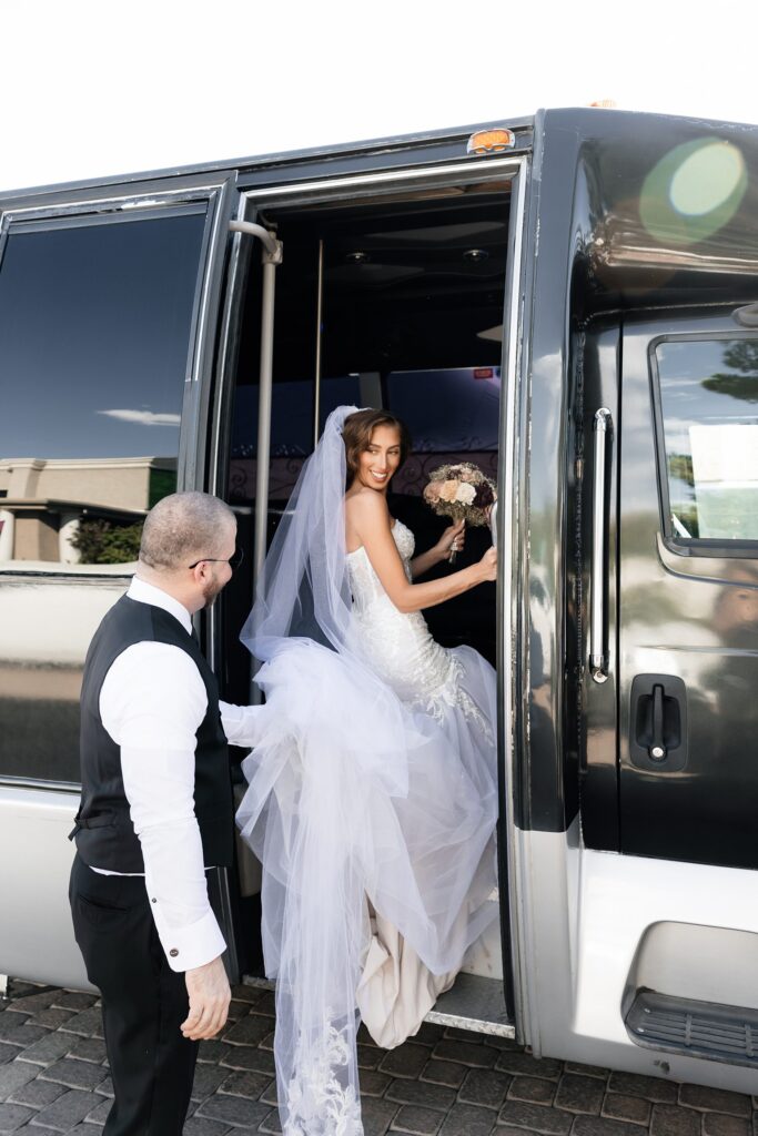 Bride and groom getting on their party bus