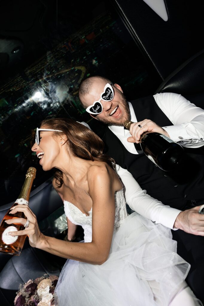 Bride and groom having fun on their party bus