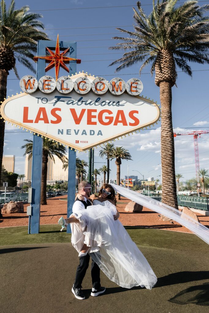 Bride and grooms portraits in front of the Welcome to Fabulous Las Vegas sign