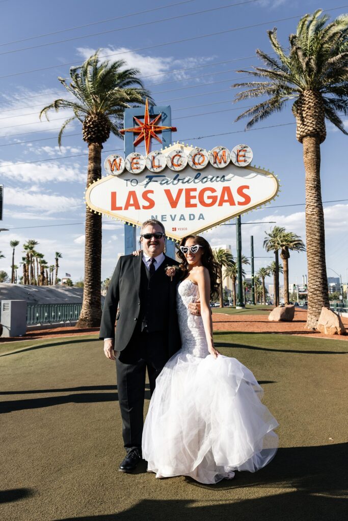 Bride and grooms portraits in front of the Welcome to Fabulous Las Vegas sign