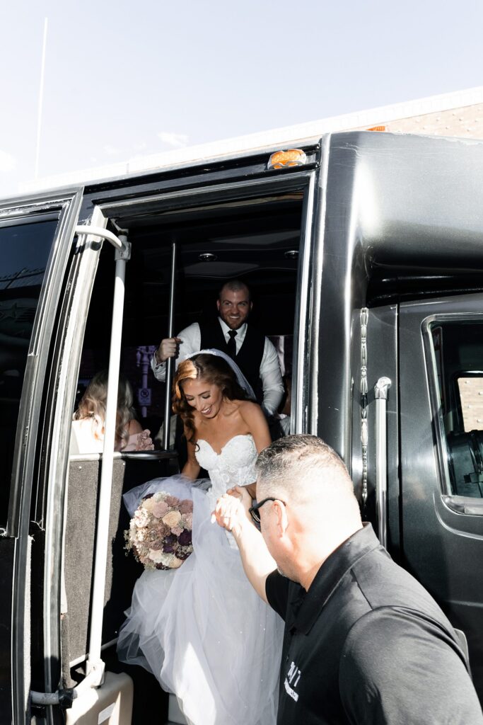 Bride and groom getting off their party bus on Fremont Street