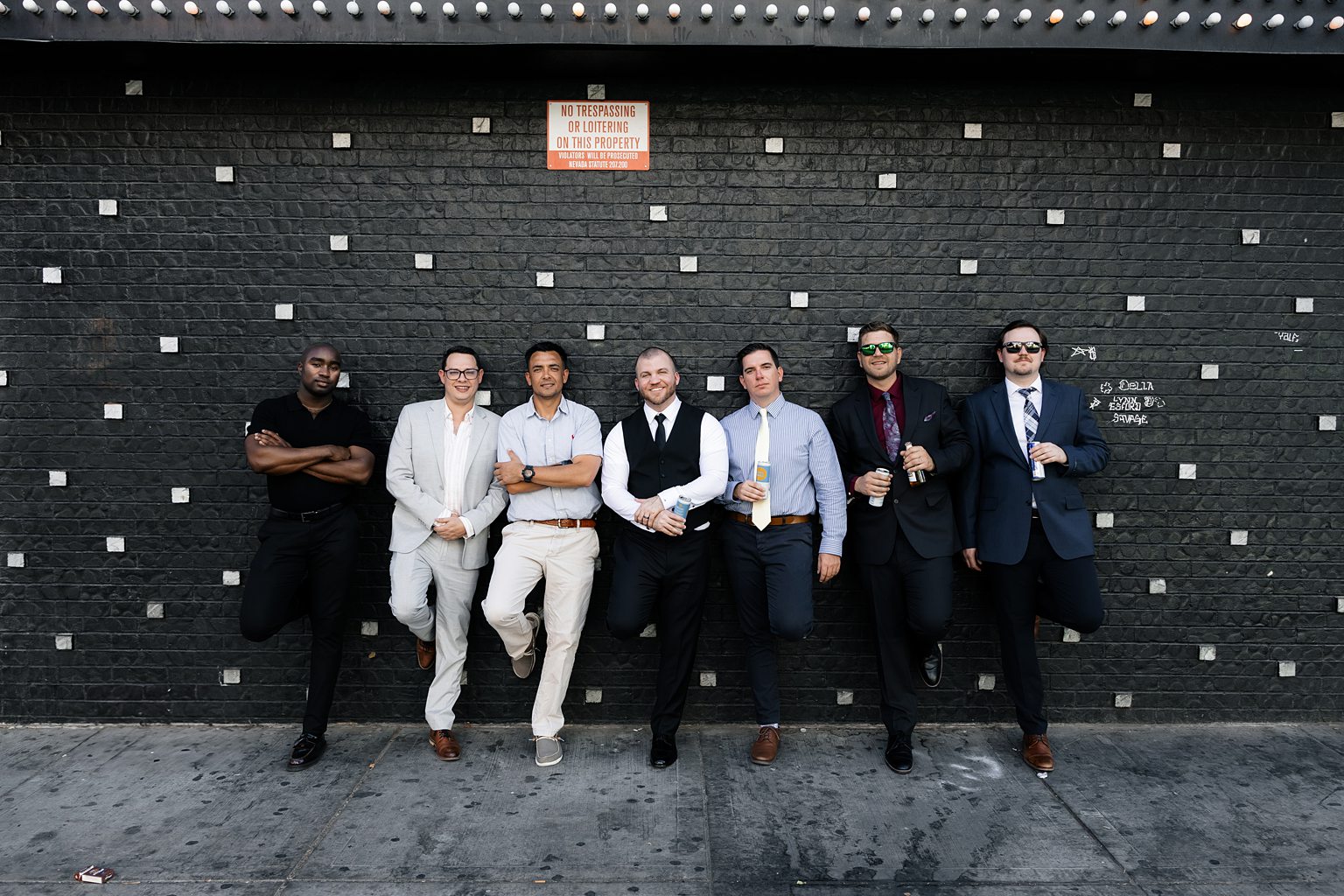 Groom and groomsmen posing on the corner of El Cortez