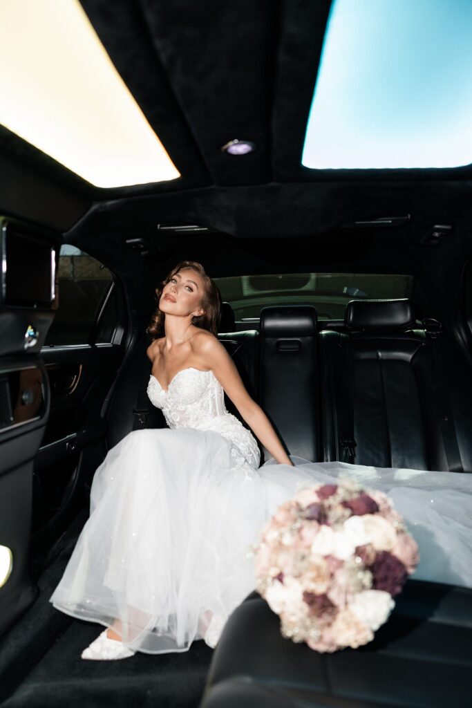 Bride sitting in a limo