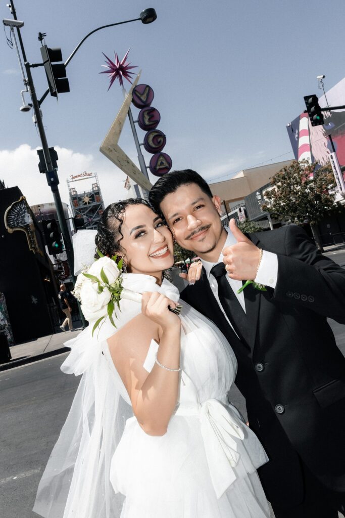 Bride and grooms Fremont Street elopement photos by the Vegas sign