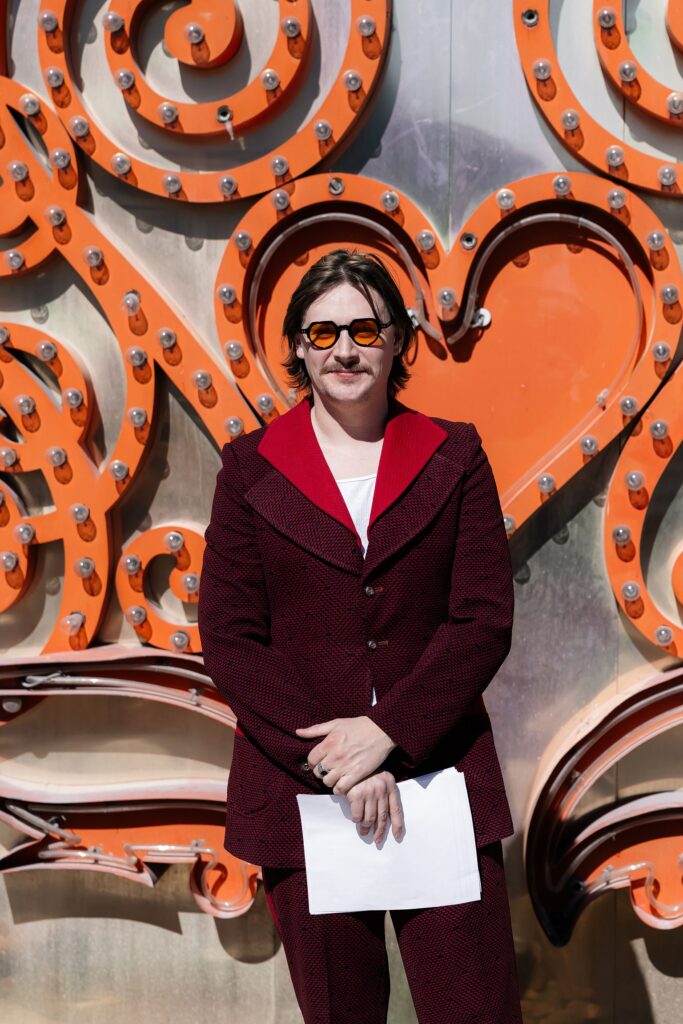 Las Vegas Neon Museum wedding officiant wearing a red suit