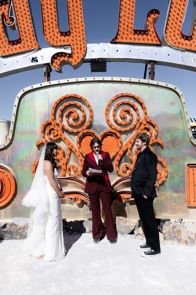 Bride and groom at the altar during their Las Vegas Neon Museum wedding ceremony