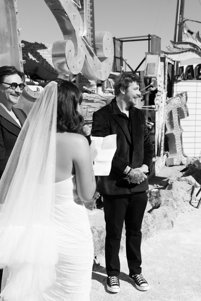 Black and white photo of a bride reading her vows to the groom