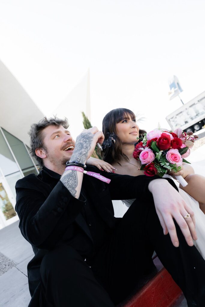 Bride and groom smoking a cigarette outside of The Neon Museum Las Vegas