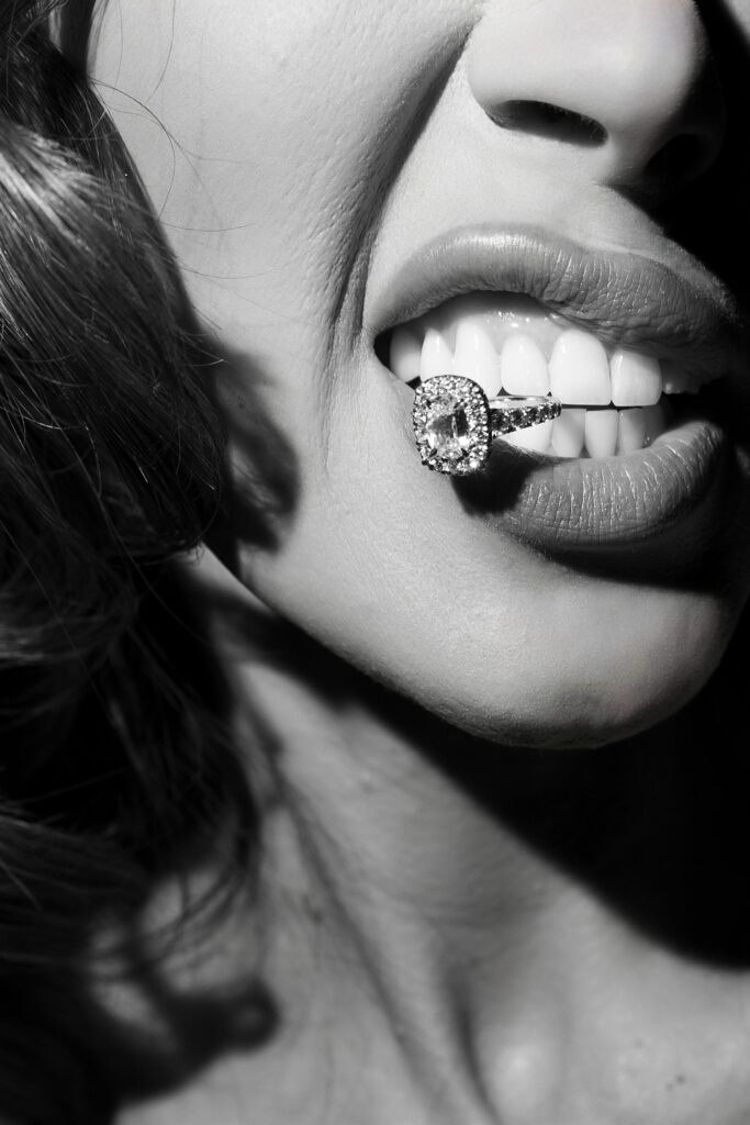 Fun wedding photo of a bride biting down on her wedding ring