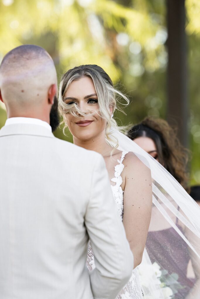 Bride looking at her groom during their outdoor Stallion Mountain wedding ceremony on The Patio