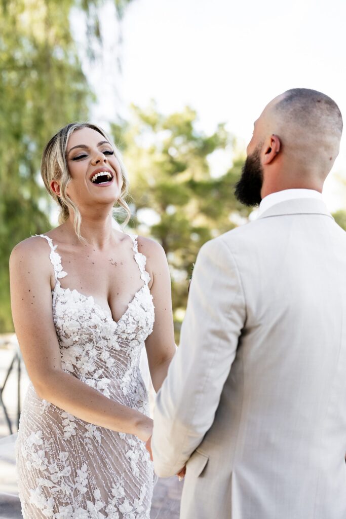 Bride laughing during her outdoor Stallion Mountain wedding ceremony on The Patio