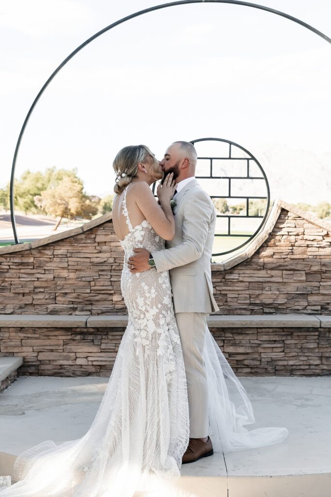 Bride and groom kissing during their outdoor Stallion Mountain wedding ceremony on The Patio