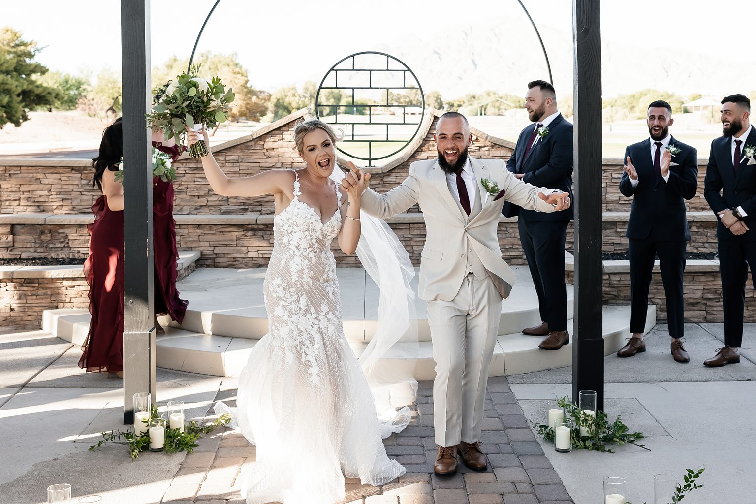 Bride and groom celebrating as they walk back down the aisle as husband and wife after their outdoor Stallion Mountain wedding ceremony on The Patio