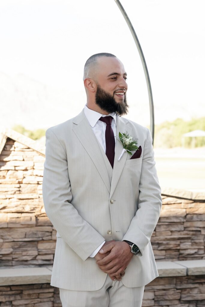 Groom watching his bride walk down the aisle during their outdoor Stallion Mountain wedding ceremony on The Patio