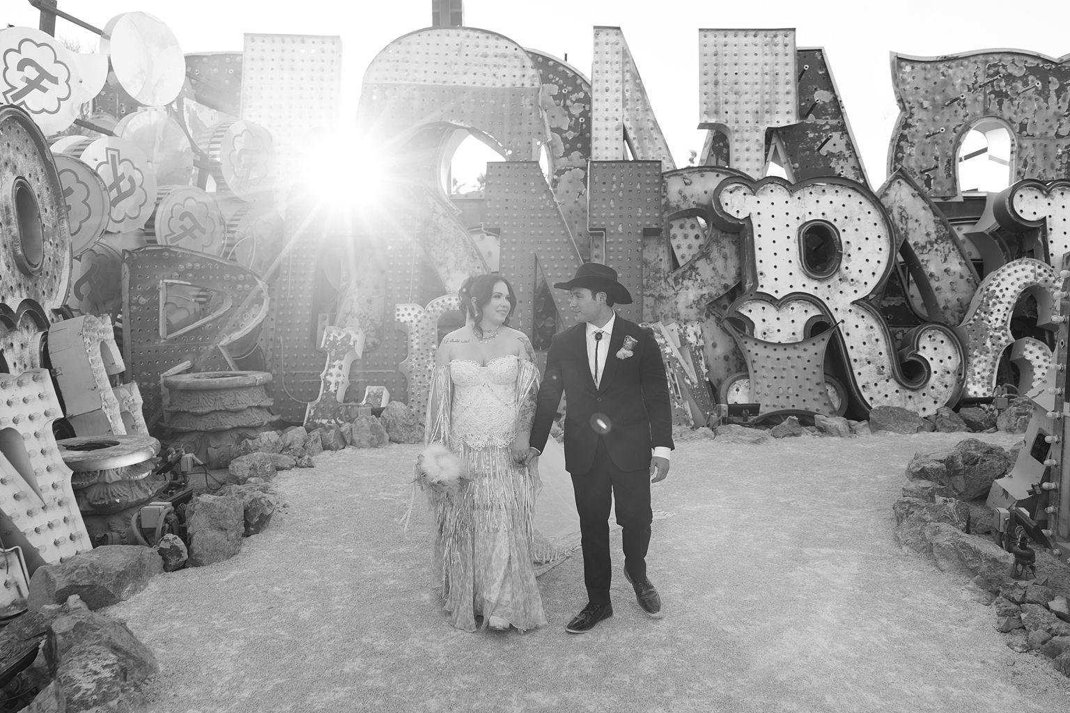 Black and white photo of a couple posing for their Neon Museum wedding photos