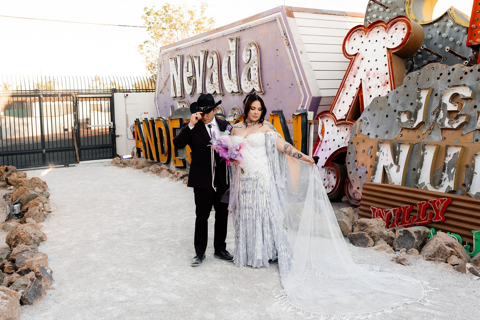 Bride and groom posing for their Neon Museum wedding photos